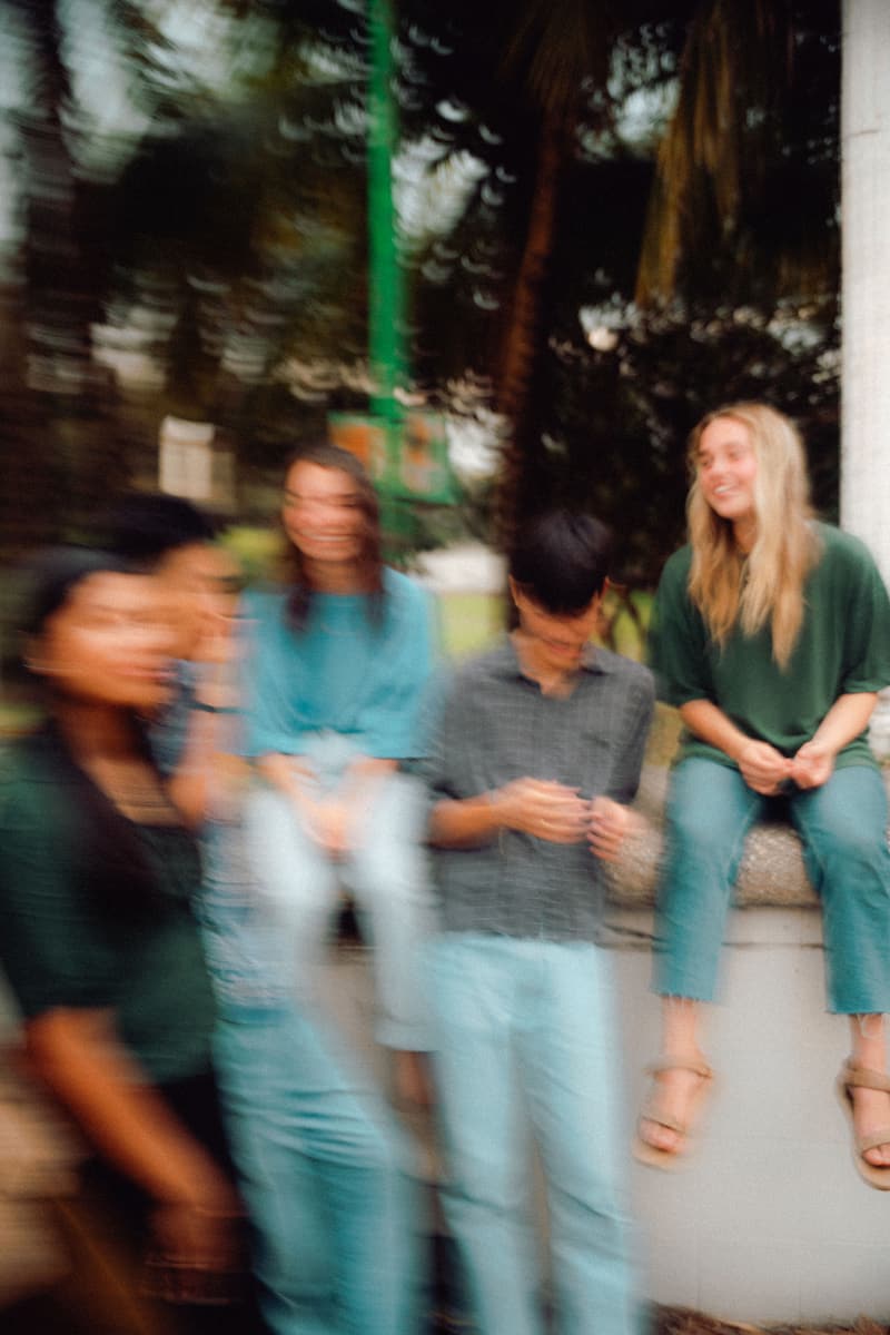 Friends laughing together at a Fire & Fragrance gathering