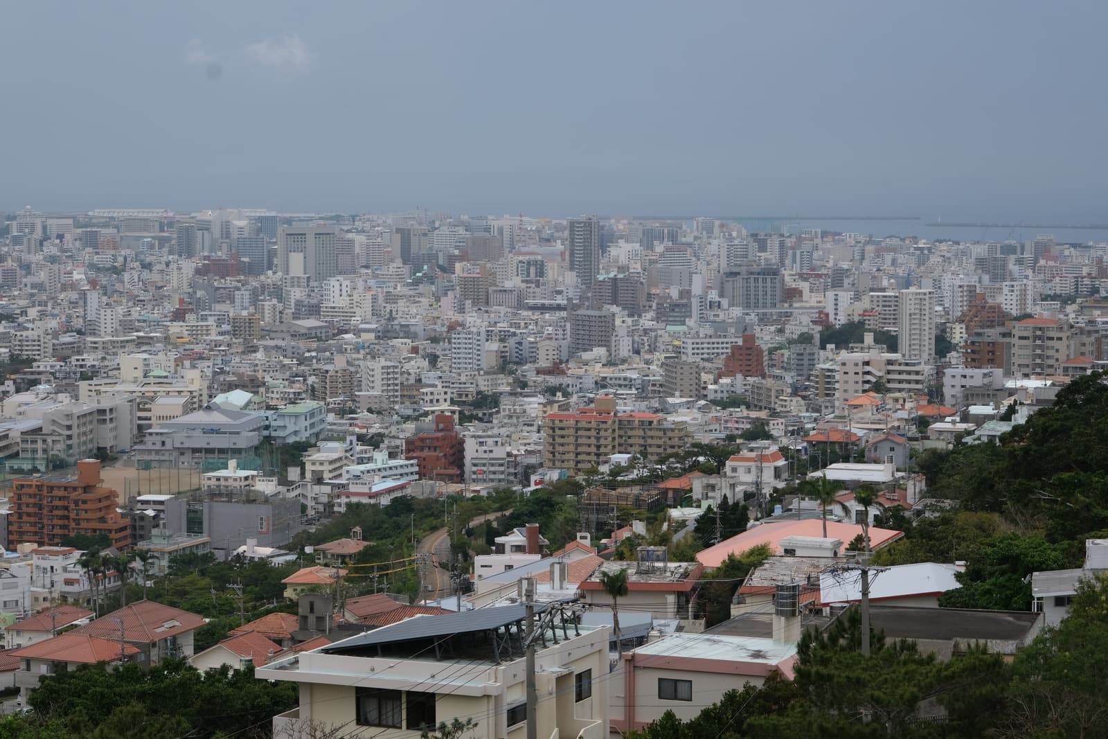 View over the rooftops of Naha to the sea