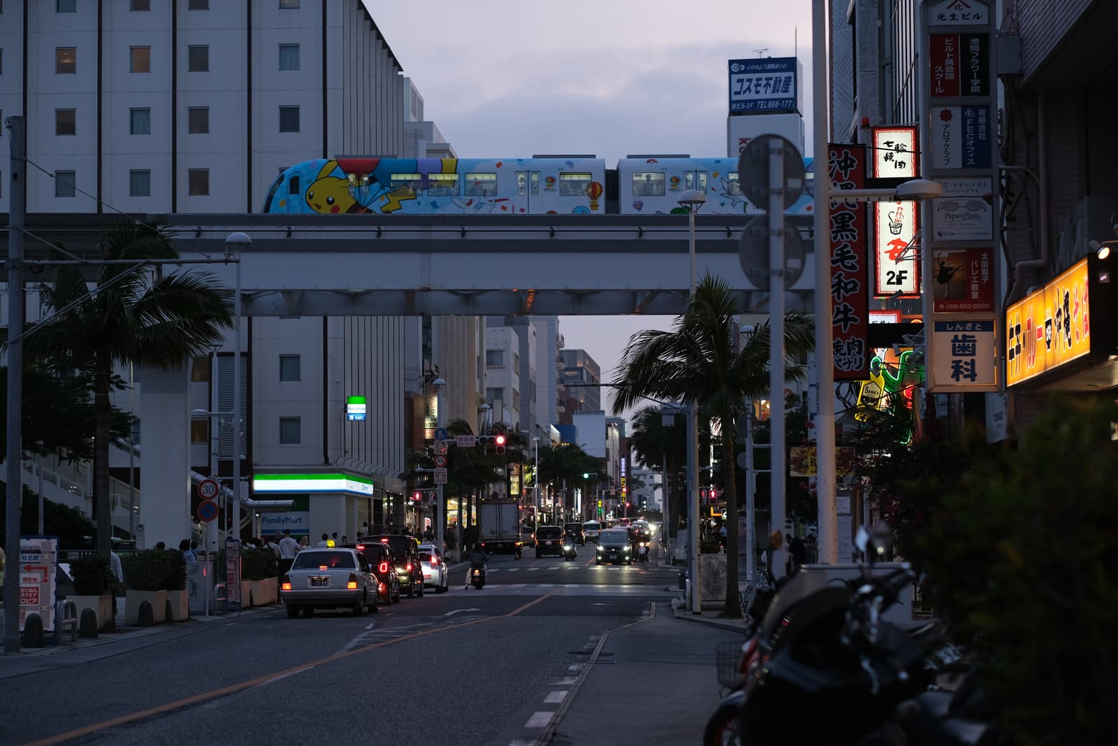 A Naha street by day, with the monorail passing overhead