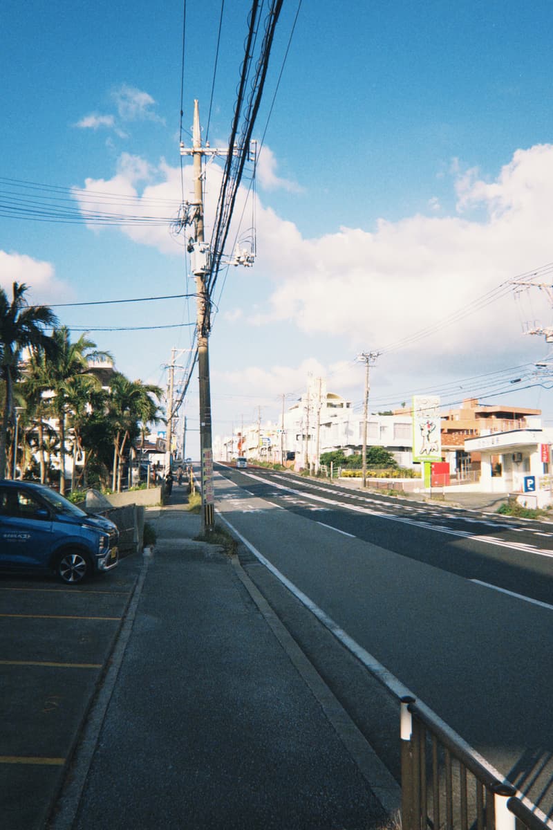 A road lined with palms under a blue sky, Okinawa